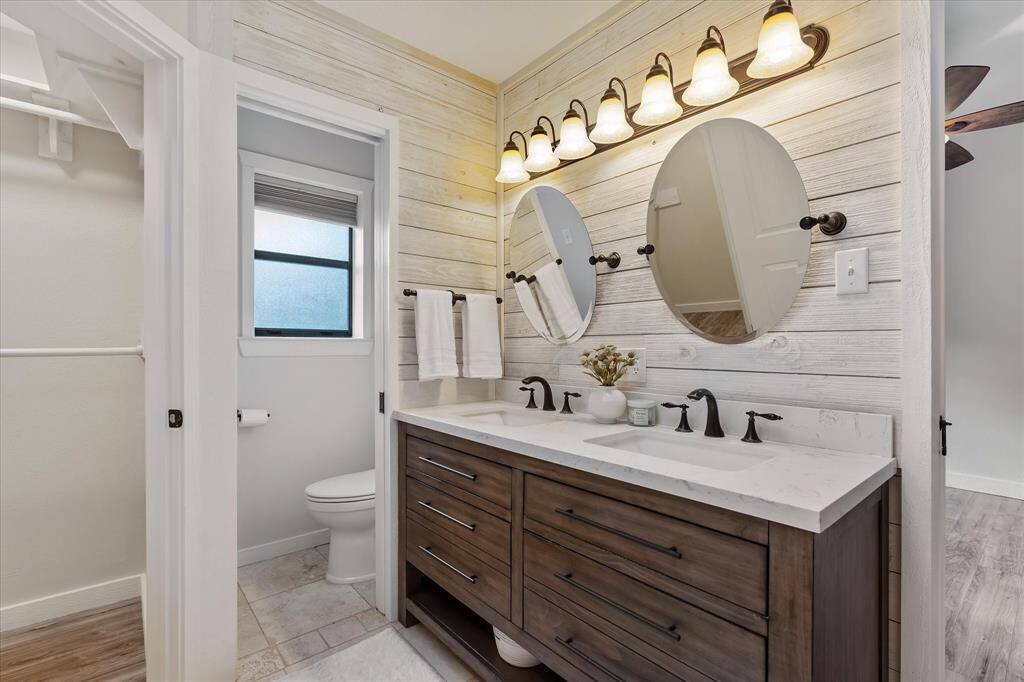 This bathroom features a convenient pocket door for added privacy in the commode area.