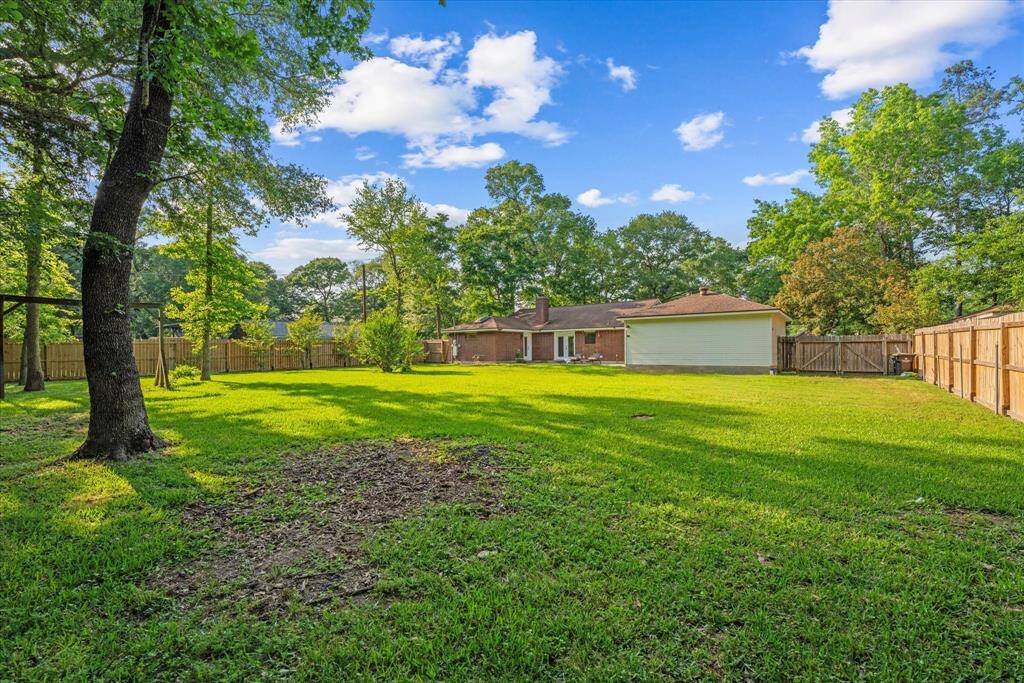Expansive backyard oasis with lush greenery and ample space for outdoor activities.
