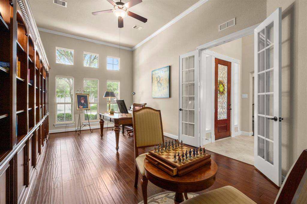 Tucked behind French glass doors with rich wood floors and coffered ceiling beams. A quiet, private workspace with classic details and charm.