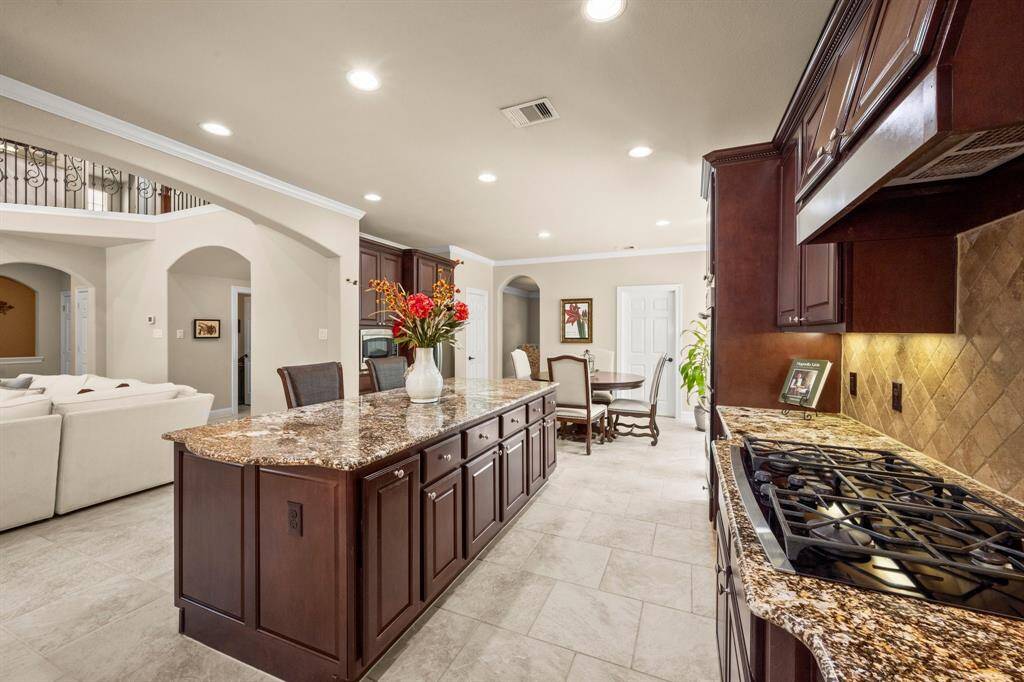 Chef-inspired layout with granite counters and a large island with storage.