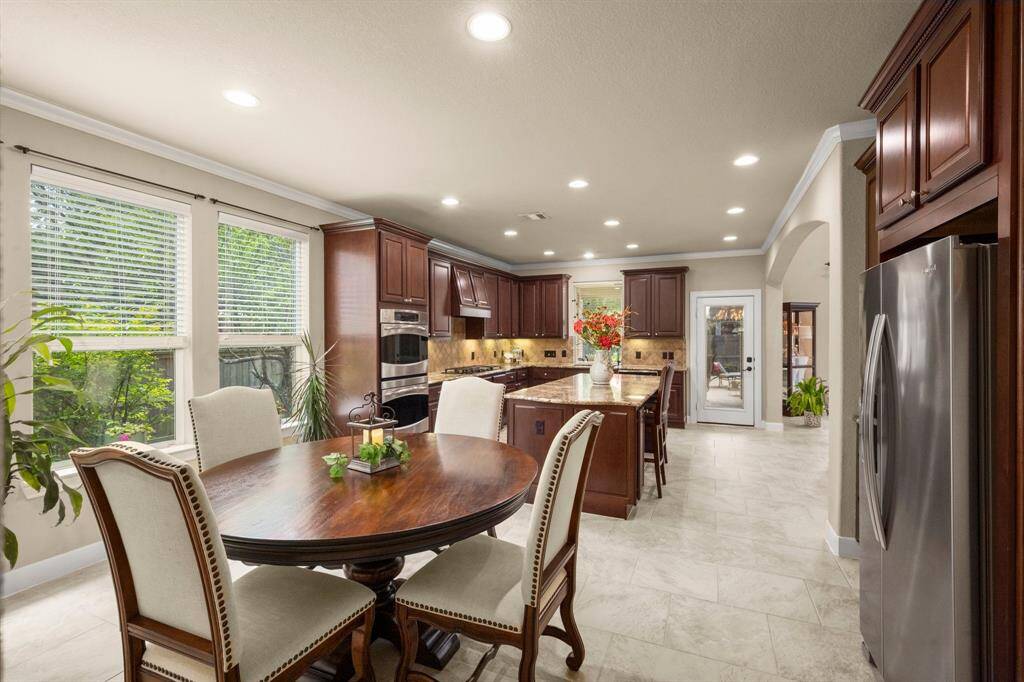 Sleek stainless steel appliances and under-cabinet lighting offer both functionality and a dash of modern flair.