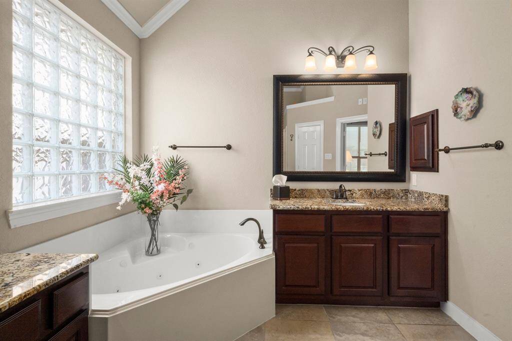 Framed mirrors and modern finishes elevate the spa-inspired space.