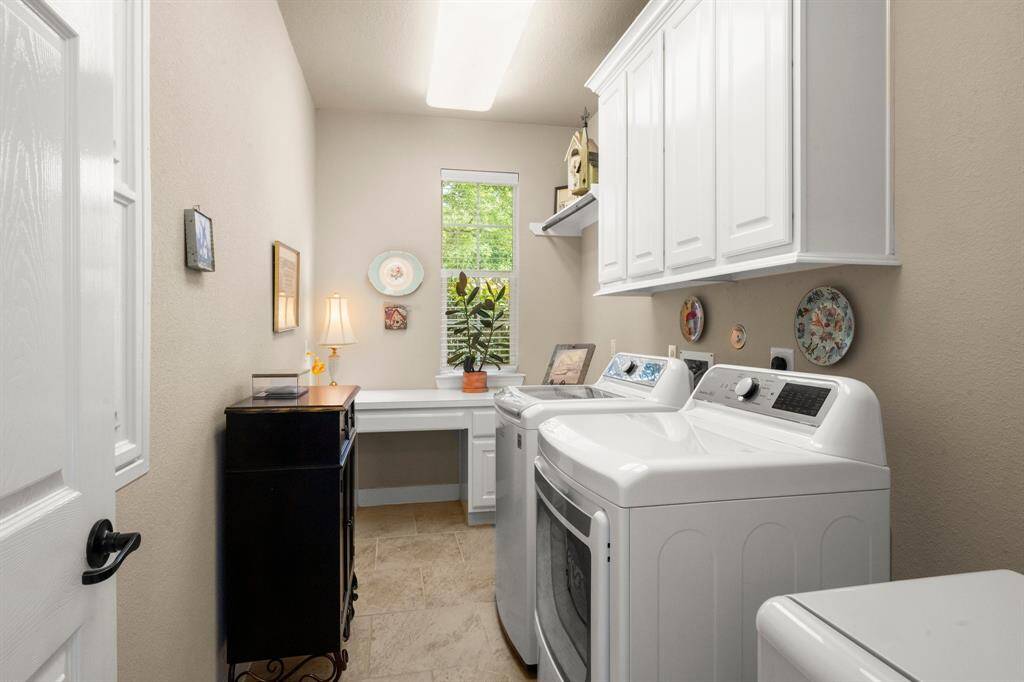 Full-sized with cabinets, workspace, and natural light. Tiled flooring and thoughtful layout make chores a breeze. Water connection for fridge adds extra utility.