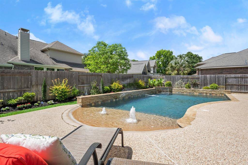 Gently sloping like a natural shoreline, the beach-entry pool offers a seamless, resort-style experience right in your own backyard.