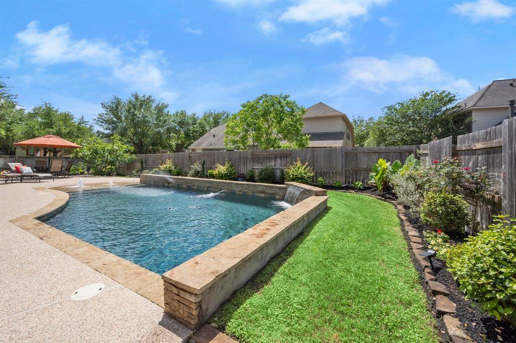 Fully fenced yard, well-landscaped and ready for fun and relaxation