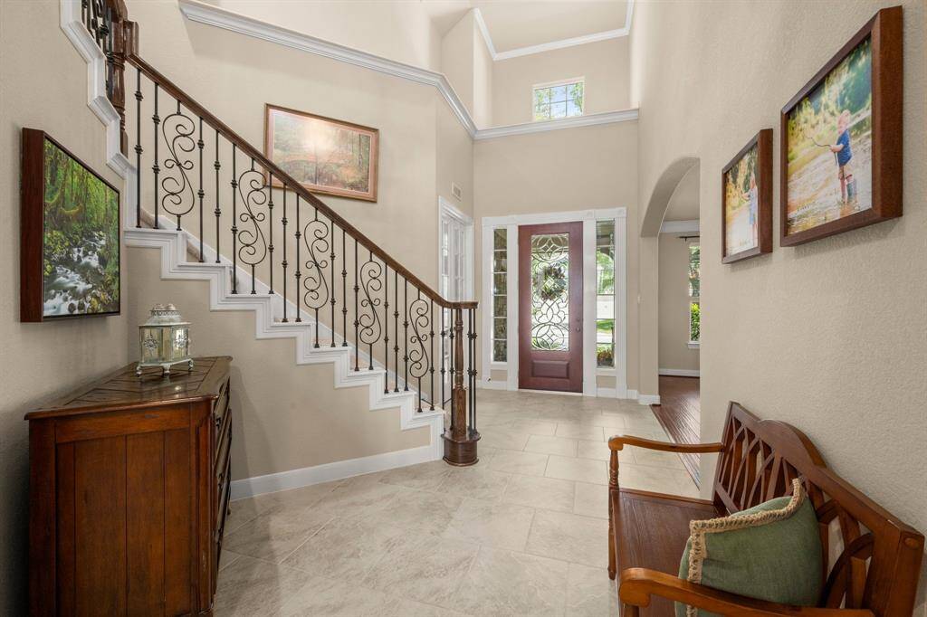 A grand entry with elegant tile flooring and crown molding.