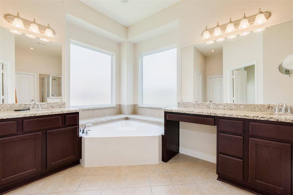 Bright open master bathroom with his and her vanities!