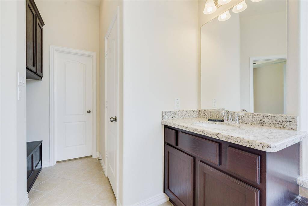 Another updated bathroom with granite countertops and an abundance of storage space!