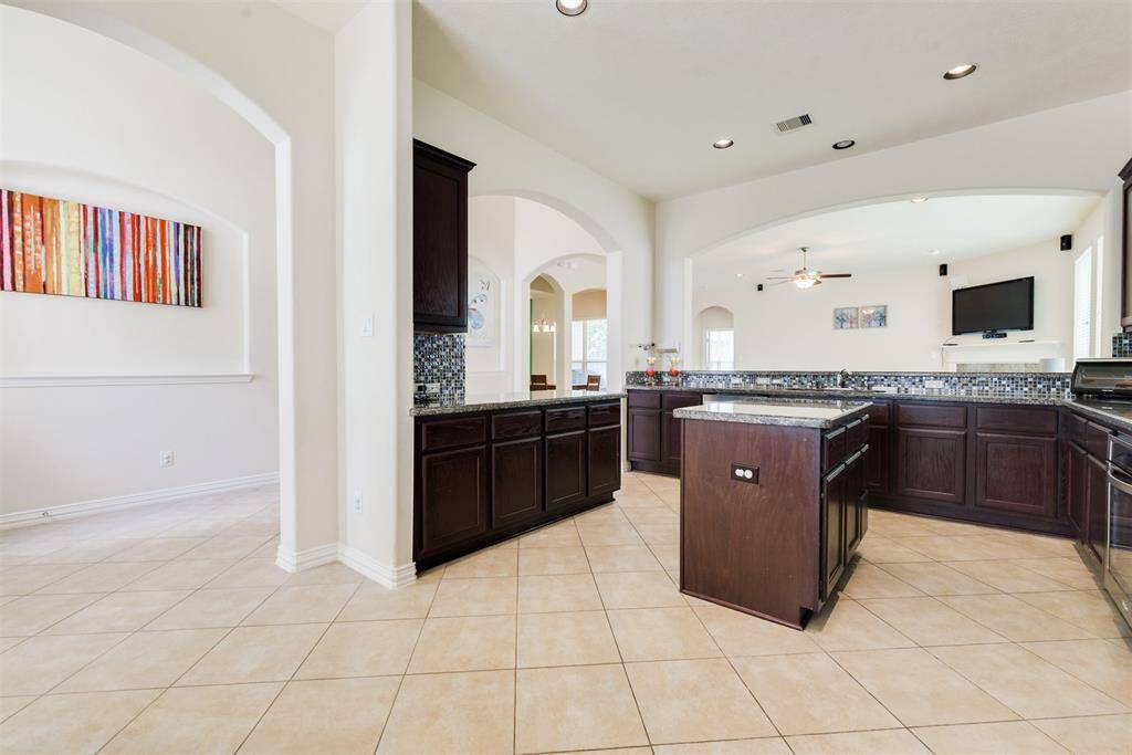 Walk inside this huge home and the kitchen is just right off the foyer with beautiful archway entries!