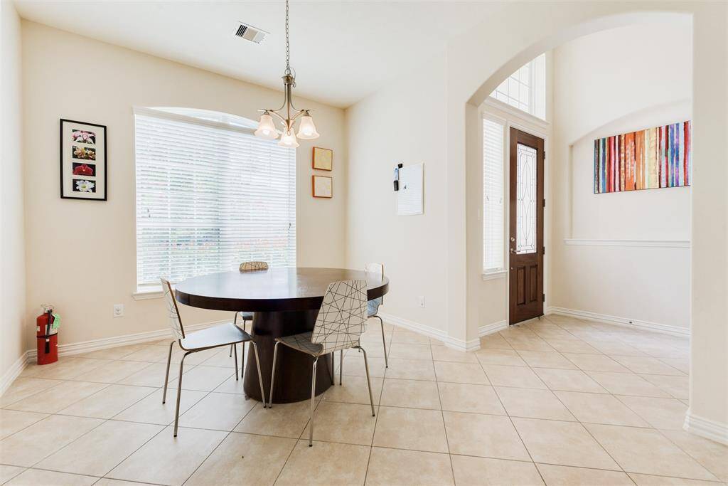Bright with natural lighting formal dining room including easy-to-maintain tile floors!