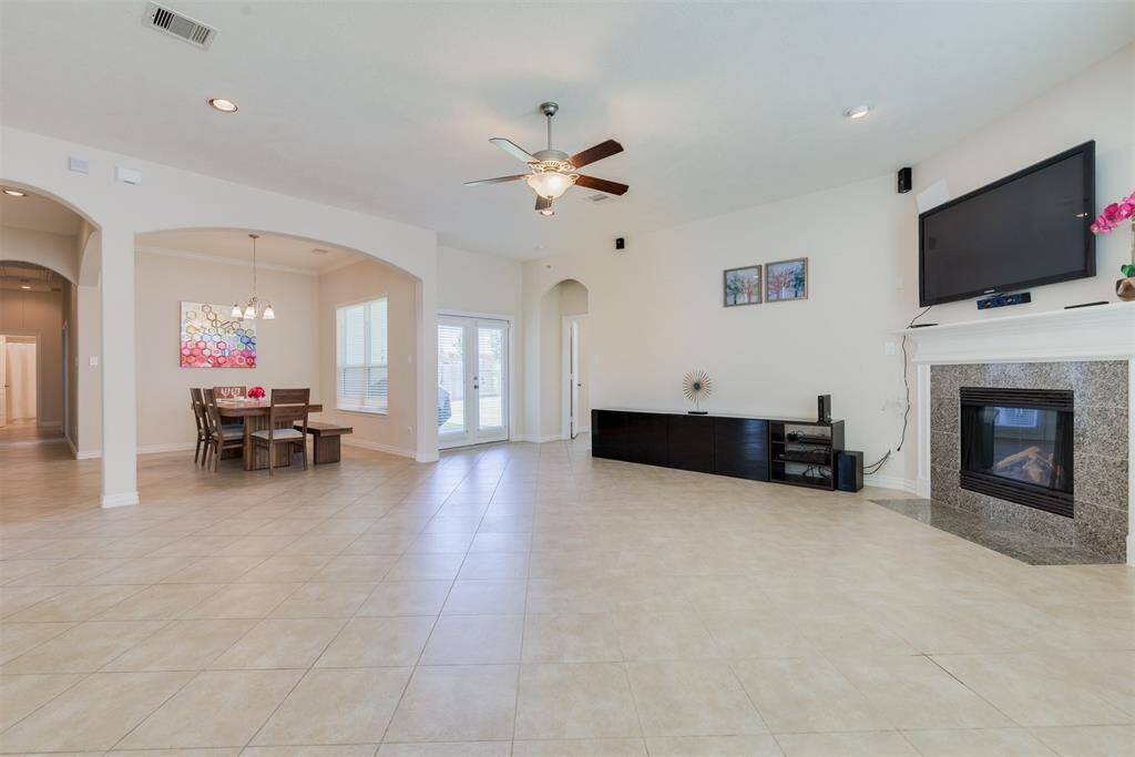 Another view of the living room, which shows off the formal dining room and gas log fireplace.