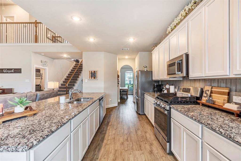 Cook in style with top-of-the-line stainless steel appliances, making this kitchen both sleek and highly functional.