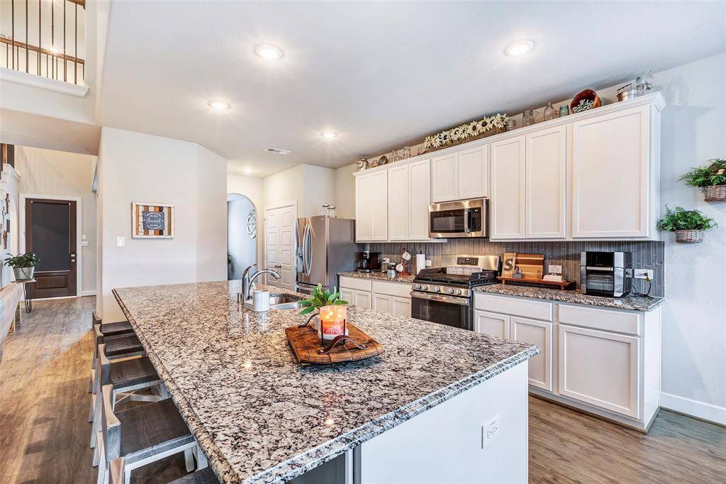 Ample minimalist cabinetry provides plenty of storage space, keeping your kitchen organized and stylish with a clean, modern look.
