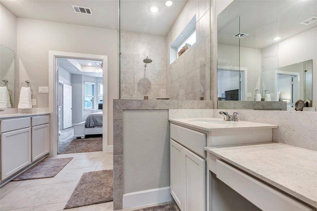 Brighten up your routine with large vanity mirrors in the main bath.