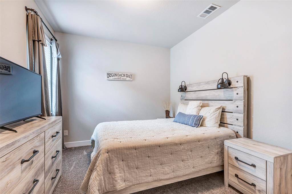 The final bedroom features a large window that floods the space with natural light.