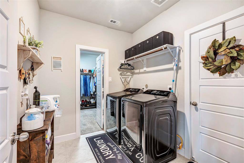 Conveniently connected to the main bedroom closet, this functional laundry room makes chores a breeze.