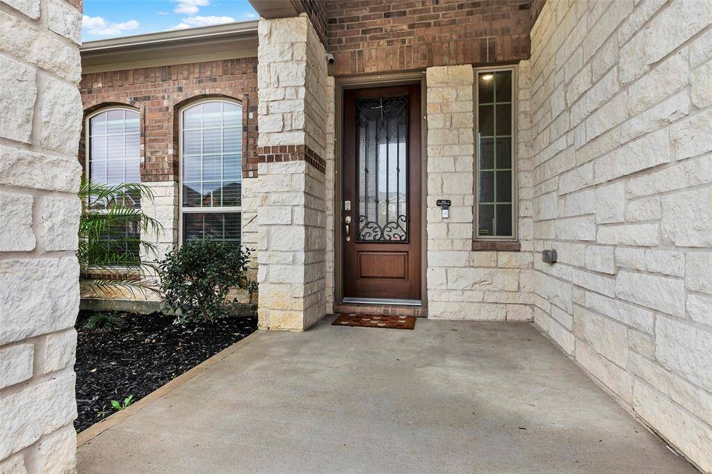 The inviting front entrance showcases intricate details of the beautiful exterior, setting the tone for the rest of this stunning property.