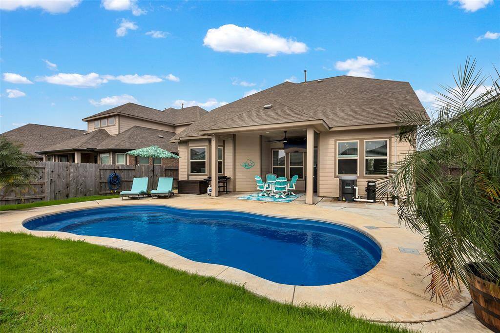 Whether you’re lounging by the pool or relaxing under the covered patio, this backyard offers the perfect spots to unwind and enjoy outdoor living.