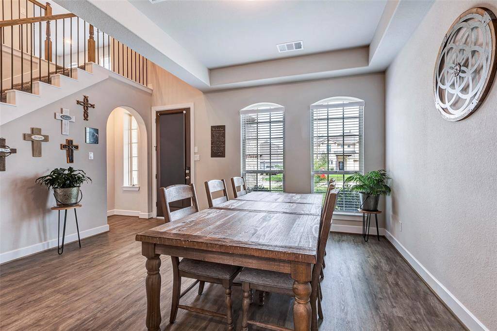 Additional view of the dining space with a glimpse of the front yard, creating a peaceful ambiance for every meal.