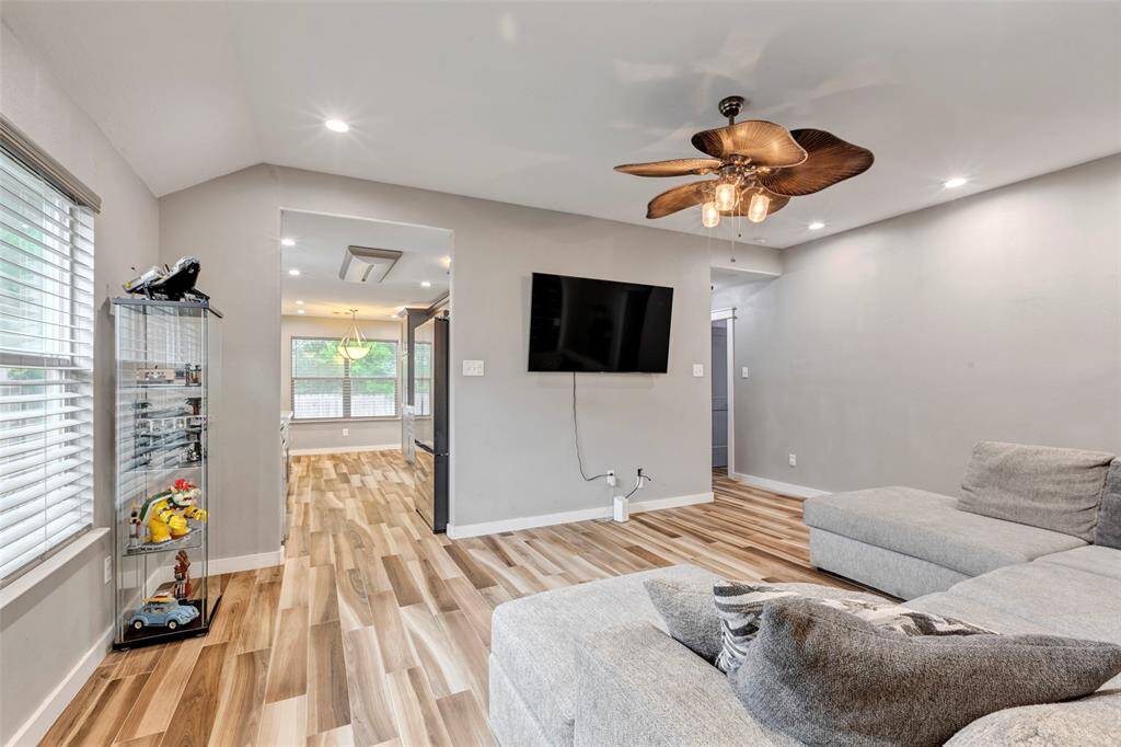 From this corner of the living room, you get a direct view into the kitchen through its open doorway, creating a seamless flow between the living and cooking spaces.