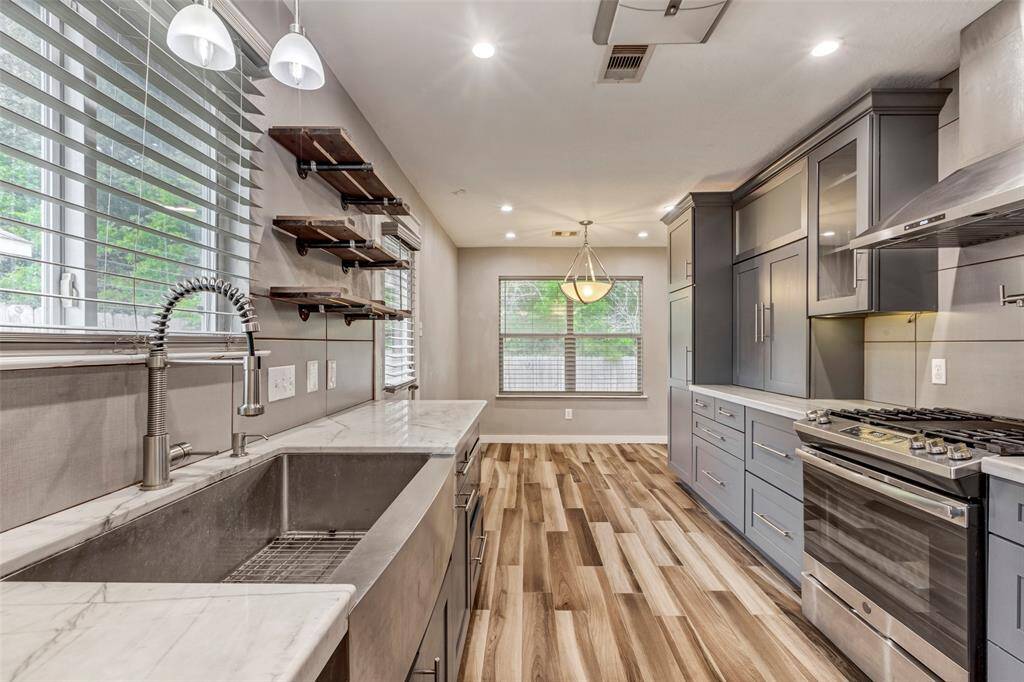 The kitchen is equipped with sleek stainless steel appliances, complemented by ample cabinets and drawers for stylish and functional storage.