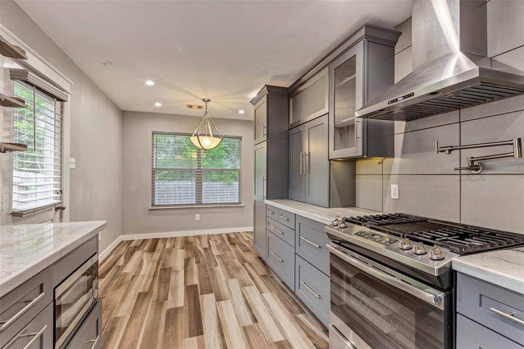 The floor, cabinets, and walls are beautifully coordinated, with complementary tones that create a warm and cohesive look throughout the kitchen.