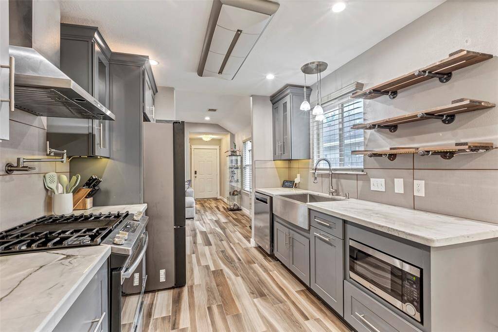 This closer view showcases the available appliances, including a gas range, gas oven, and built-in dishwasher—ready for all your cooking and cleaning needs.