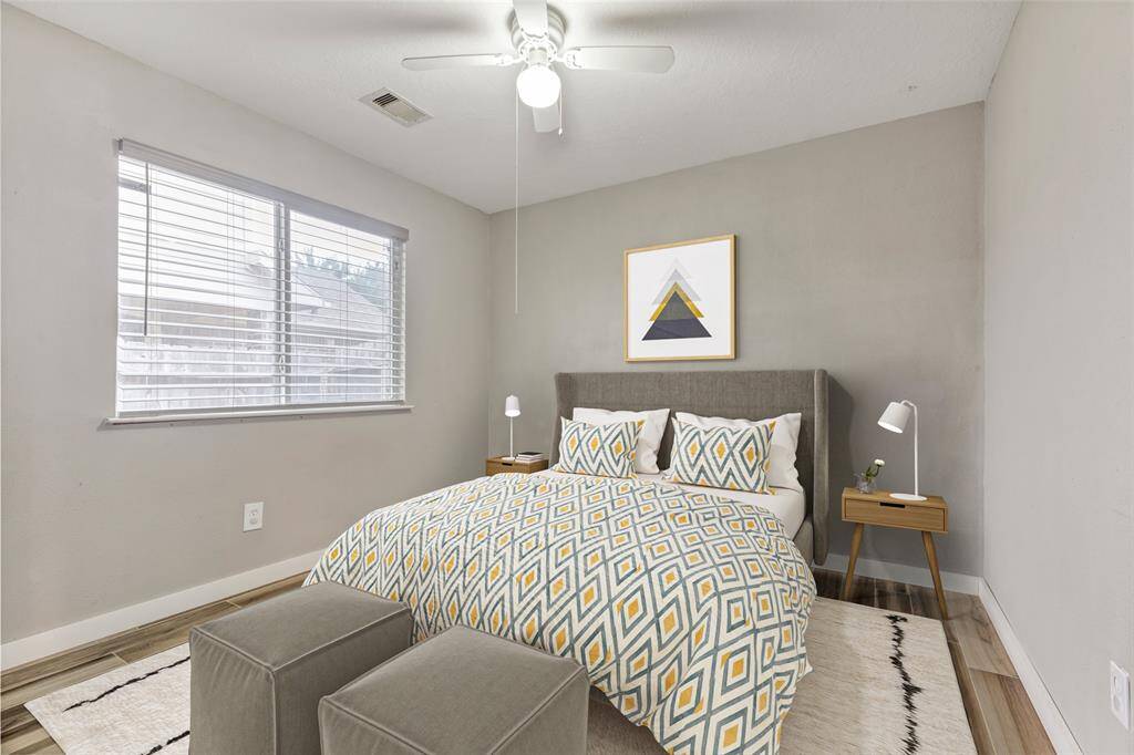 The first bedroom, located across from the office, offers a versatile space that the new owner can personalize. (Virtually Staged)