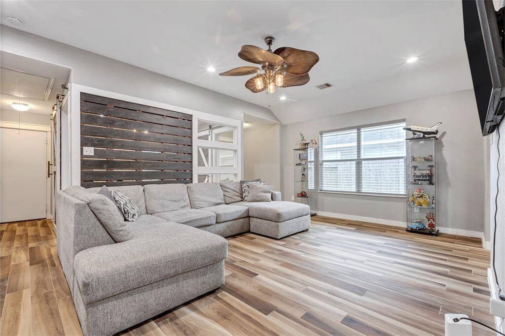 A closer look at the inviting living room, featuring a clear view into the adjacent flexible room.