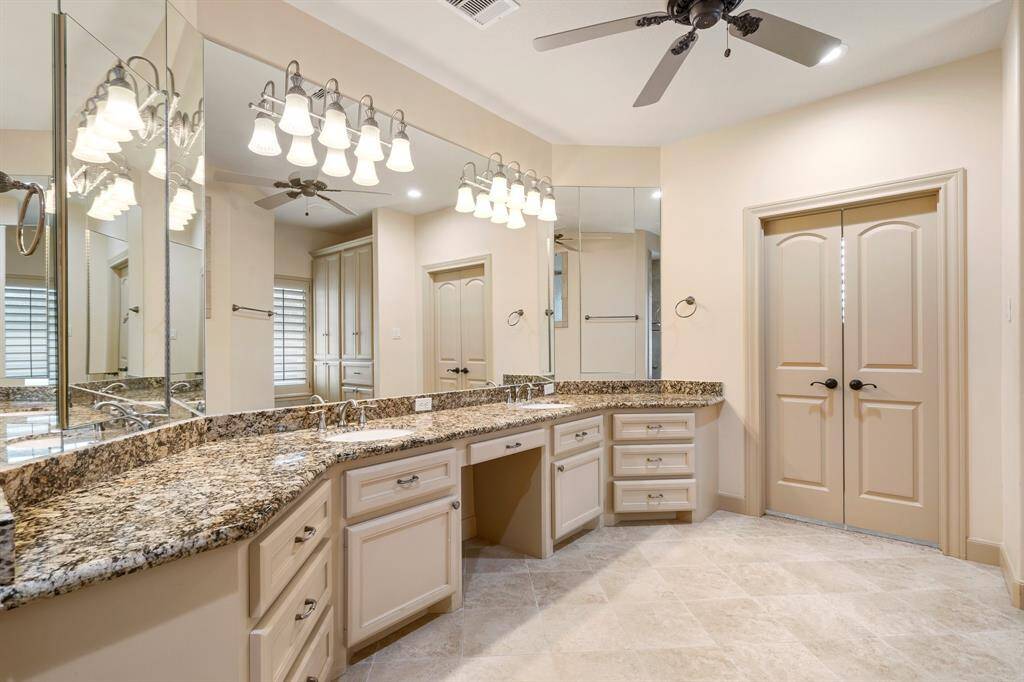 Primary bathroom suite has double sinks, vanity area and an oversized walk in shower.