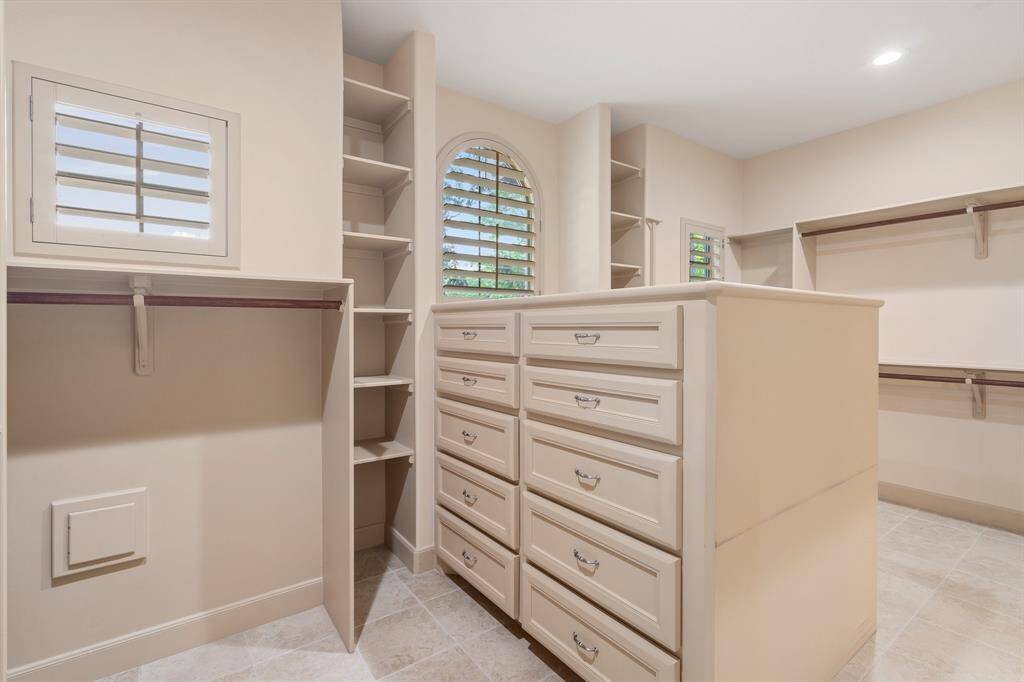 Primary closet has built-ins and lots of natural light.