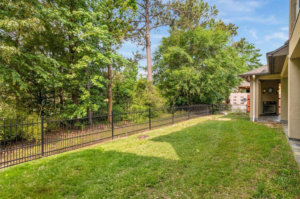 Wrought iron fencing with a wooded view. Home backs to golf course and has gate access for your golf cart.