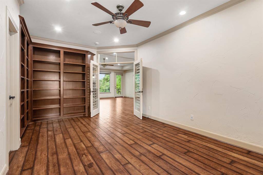 Another view of the study with built-in book shelves and French Doors.