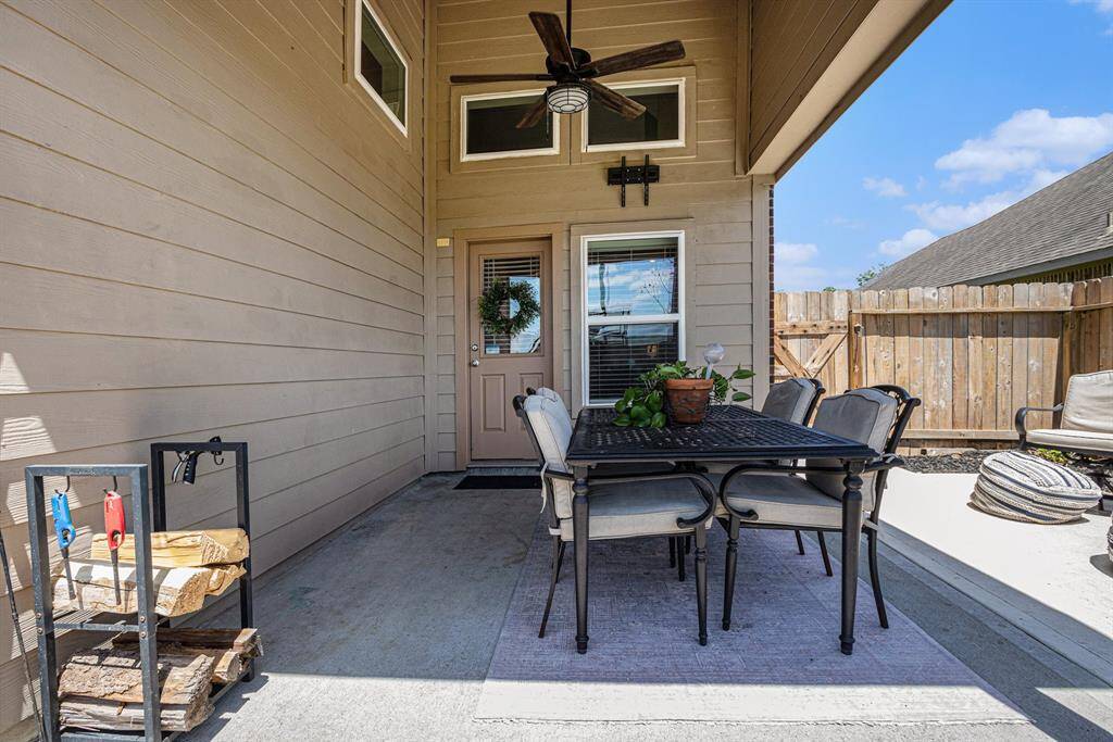 Wall bracket for your TV to watch games, in comfort, on this covered patio with ceiling fan.