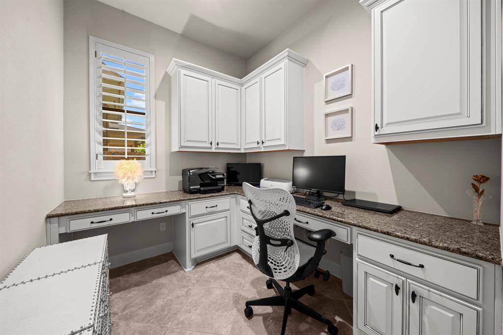 The office is tucked privately near the kitchen with 2 desk spaces, granite counters and custom cabinets