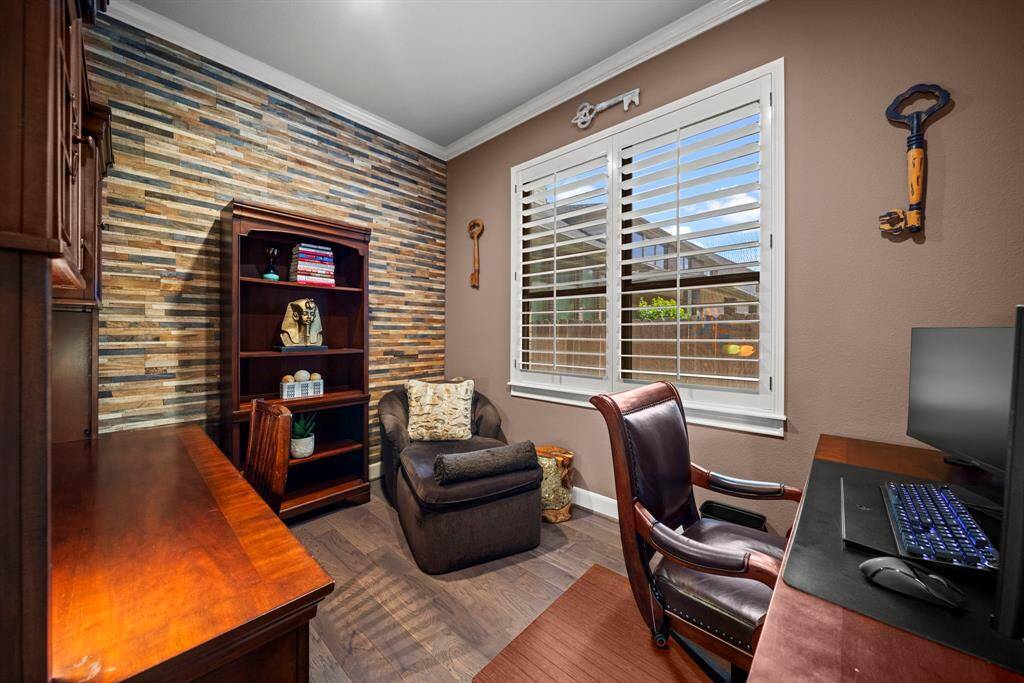 Flex room currently being used as his office, wood shiplap wall, wood floors and natural light from window with plantation shutters