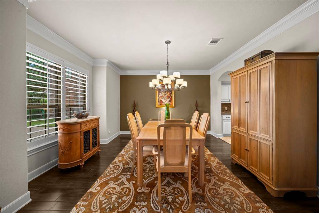 Formal Dining with triple crown molding and wood floors