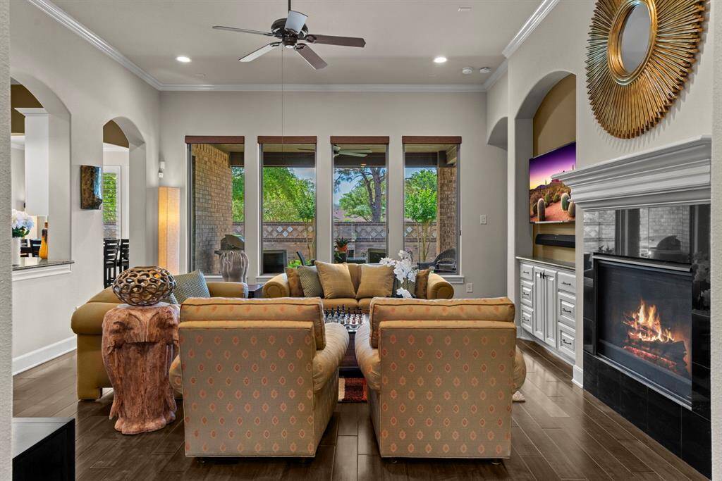 Wall of windows in the den provides beautiful views of landscaped backyard