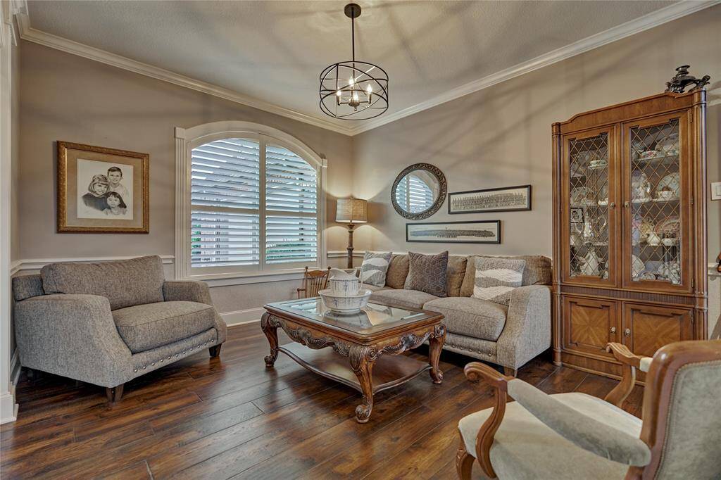 Crown molding, rich flooring and plantation shutters create a comfortable conversational space for you and your guests.