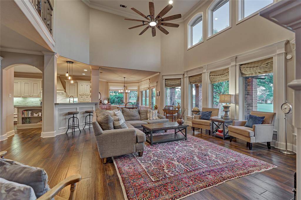 Custom Roman Shades adorn the wall of windows in the family room.