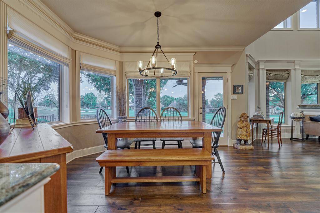 Beautifully updated lighting and roman shades in the breakfast room.
