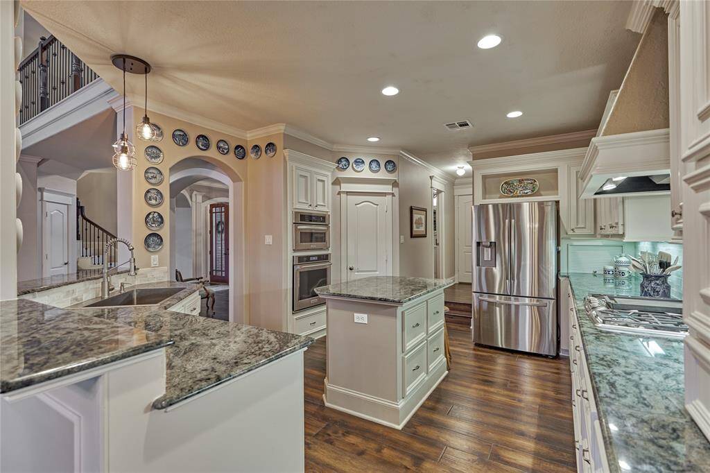 This stunning kitchen features gorgeous granite counters, stainless appliances and abundant storage.