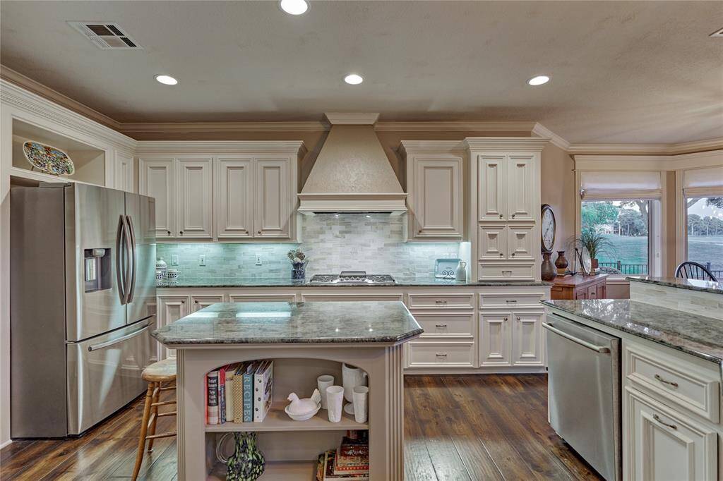The backsplash was recently updated and blends harmoniously with the gleaming granite countertops.