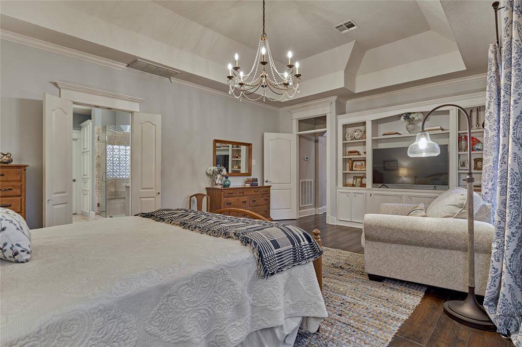 Elegant lighting, a sitting area and built-in cabinetry create a welcoming space to unwind in.