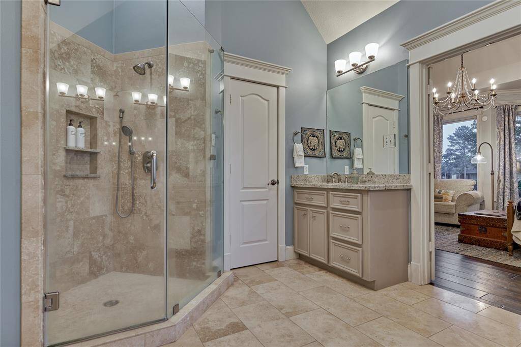 A vanity and frameless walk-in shower for the man of the house.