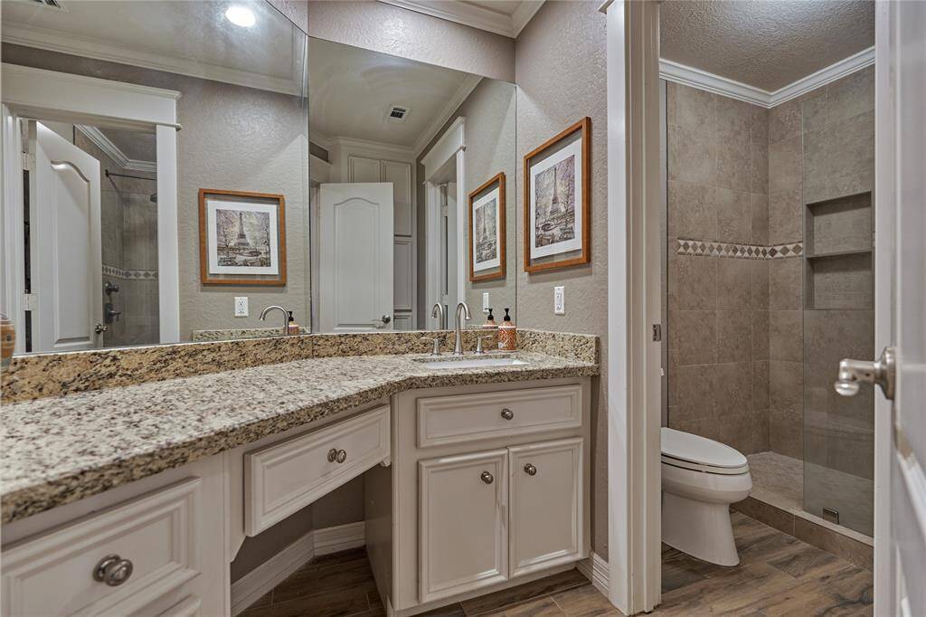 Second floor shared bath with granite counters and walk-in shower.