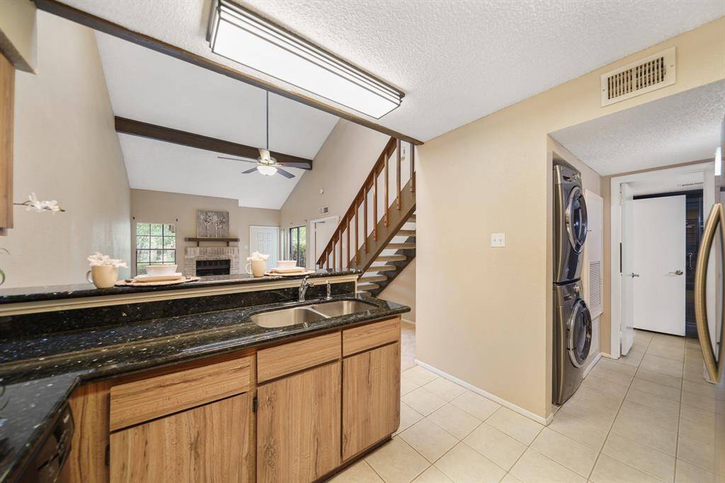 A corridor located just off the kitchen houses a full-size washer & dryer and offers semi-private access to the full bath.
