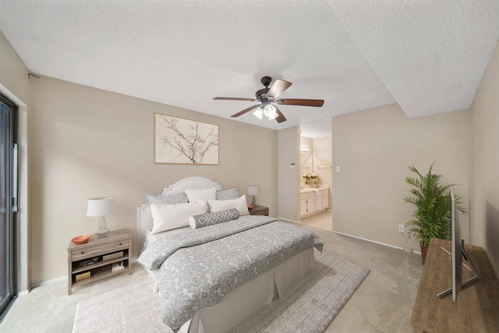 Accessible via a double door entry from the living room is the first floor owner's suite. This photo has been virtually staged.