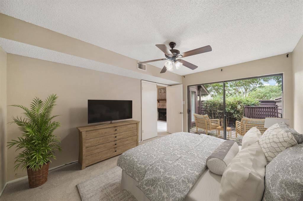 A sliding glass patio door overlooks the patio and provides plenty of natural light along with private access to the patio. This photo has been virtually staged.