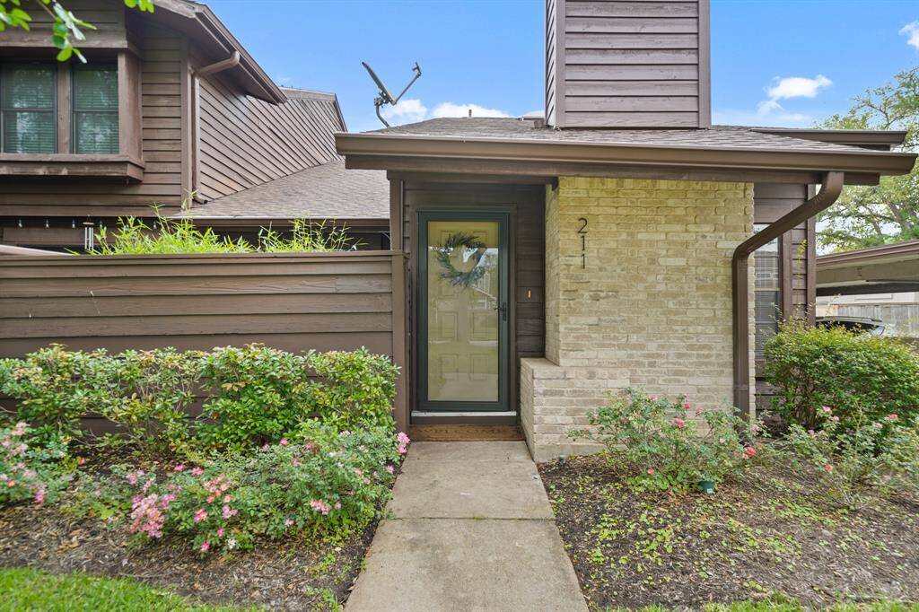 Welcoming, the covered front porch features a light fixture and a walkway leading to the sidewalk. Plenty of guest parking is conveniently located nearby.